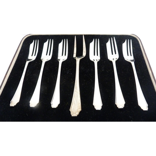 245 - Set of six silver cake forks and a larger fork, in fitted case.