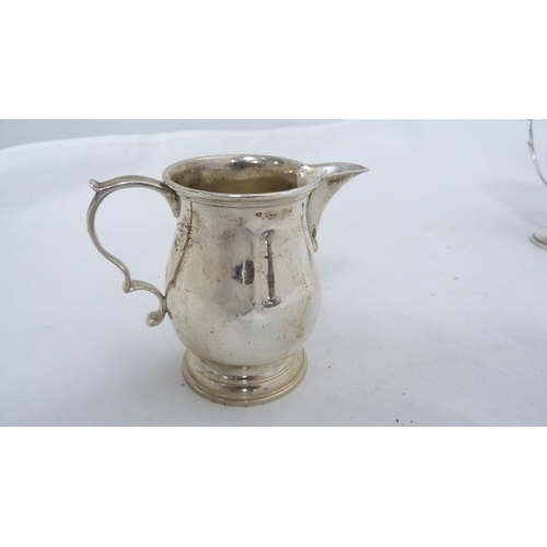 247 - Small silver twin-handled prize cup and a silver cream jug, 182g gross.  (2)