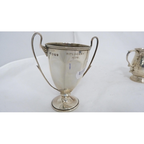 247 - Small silver twin-handled prize cup and a silver cream jug, 182g gross.  (2)