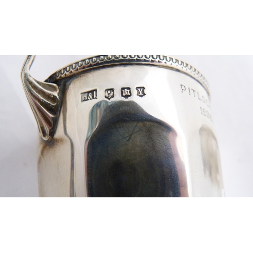 247 - Small silver twin-handled prize cup and a silver cream jug, 182g gross.  (2)