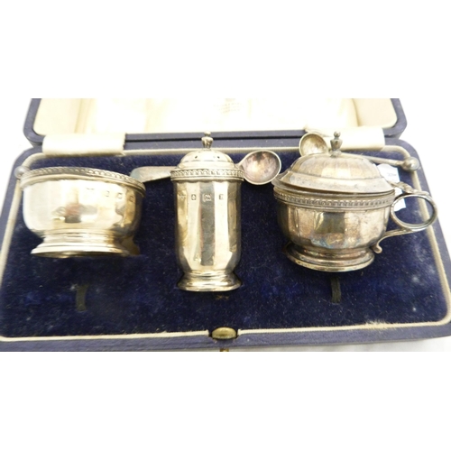 266 - Silver three-piece condiment set by Mappin & Webb, cased, and white metal condiment spoons.