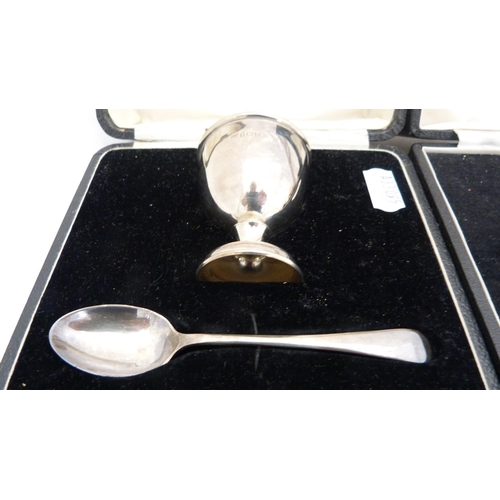 267 - Two boxed silver christening sets, each comprising an egg cup and spoon.