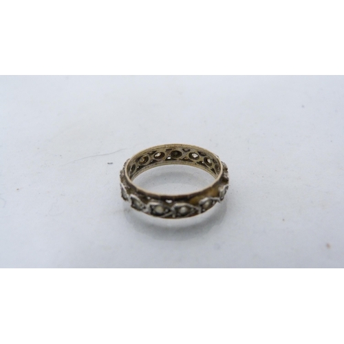 286 - 9ct gold diamond flowerhead cluster ring (3.2g gross) and an unmarked eternity ring.  (2)