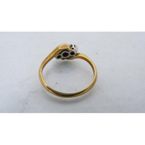 289 - 18ct gold lady's dress ring set with a small ruby, 2.4g gross.