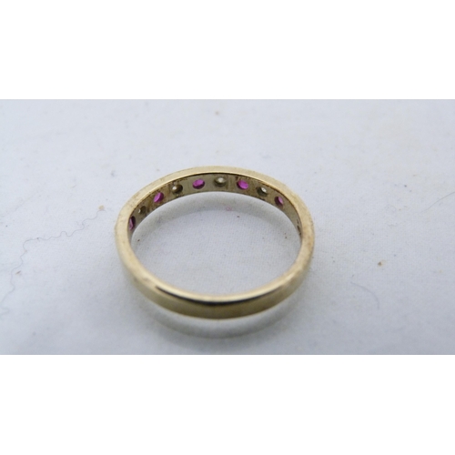 297 - Lady's 14ct gold ruby and diamond-set nine-stone ring, 2.3g gross.