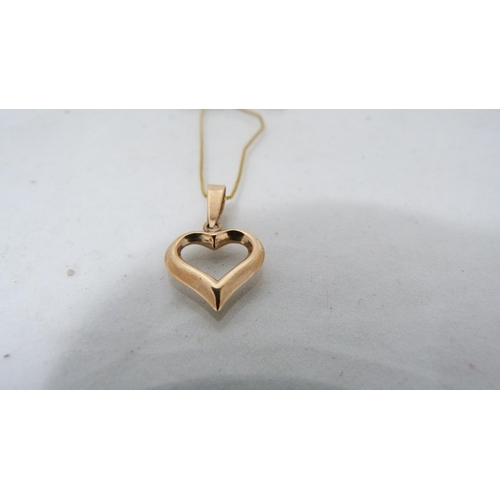 306 - 9ct gold heart-shaped pendant on chain and a 9ct gold chain with similar unmarked pendant, gold cont... 