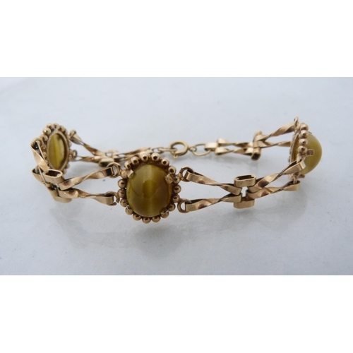 325 - 9ct gold lady's tiger's eye-style agate bracelet, 12.7g gross.