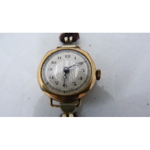 326 - Antique 9ct gold lady's gold-backed wristwatch on a black mourning strap (approximately 17g gross), ... 