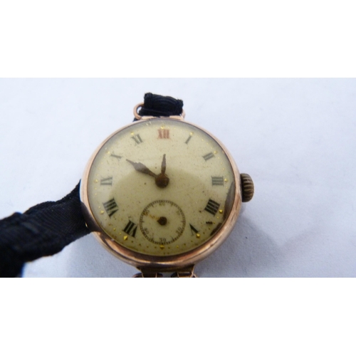 326 - Antique 9ct gold lady's gold-backed wristwatch on a black mourning strap (approximately 17g gross), ... 