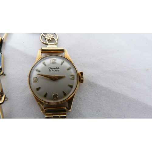 334 - 14ct gold-backed lady's wristwatch on rolled gold strap.