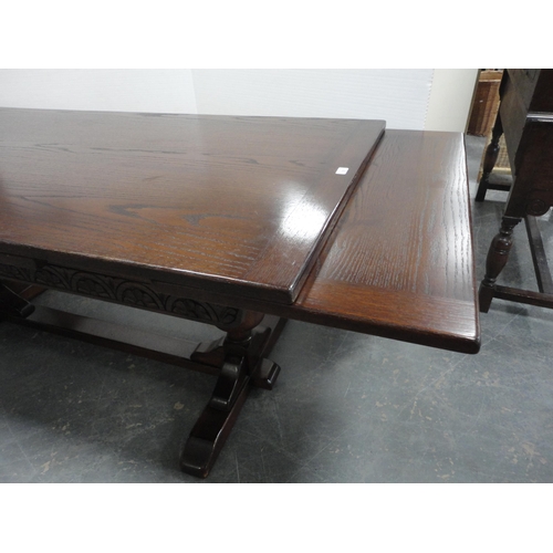 362 - Oak pull-out extending dining table on pineapple column supports.