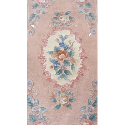 367 - Chinese-style floral rug on pink ground.