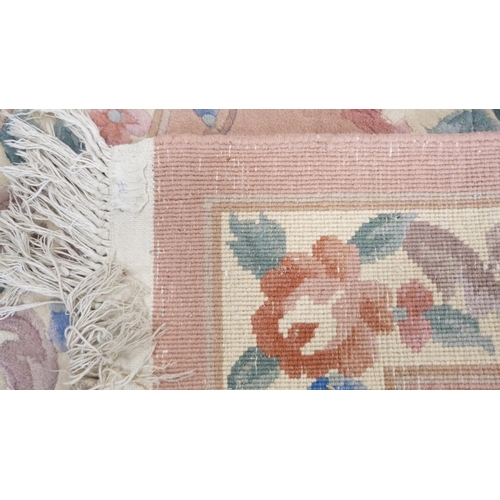 367 - Chinese-style floral rug on pink ground.