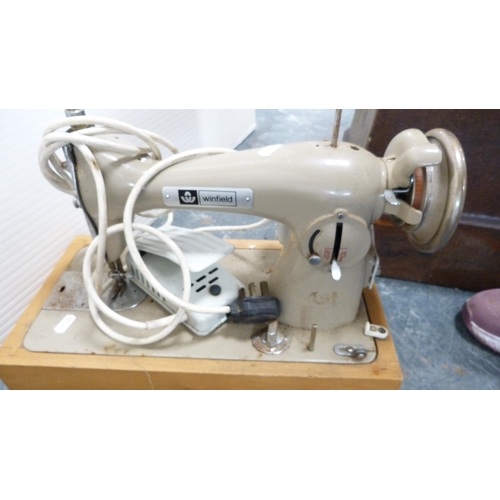 373 - Singer portable sewing machine and a Winfield portable sewing machine, with accessories.  (2)