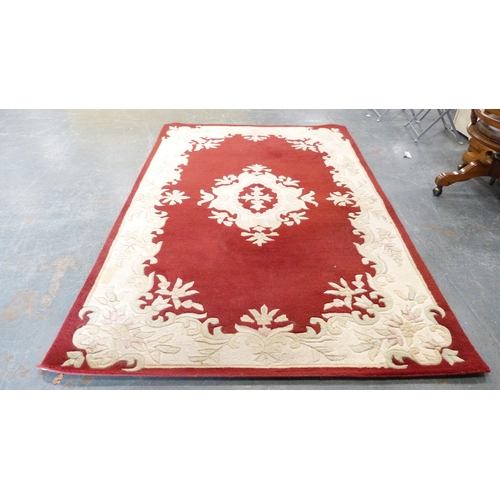 381 - Chinese-style rug on red ground.