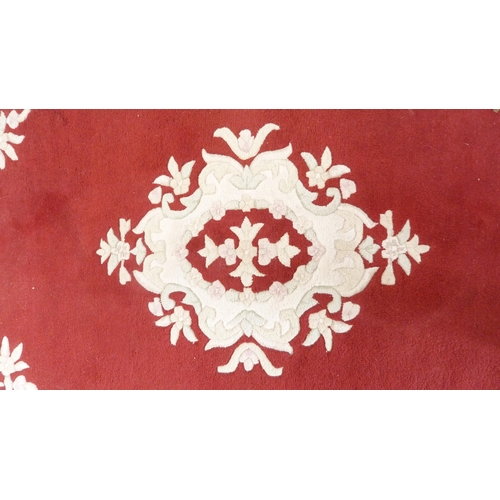 381 - Chinese-style rug on red ground.