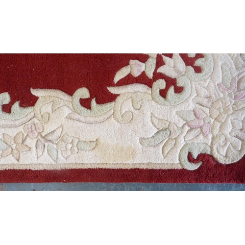 381 - Chinese-style rug on red ground.