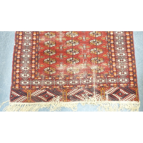 395 - Turkish Tekke hand-knotted rug on red ground.