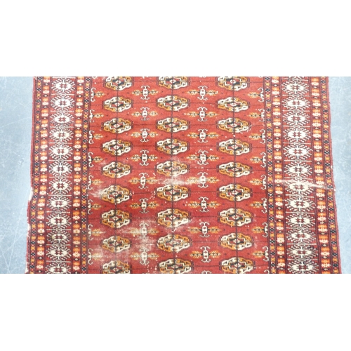 395 - Turkish Tekke hand-knotted rug on red ground.