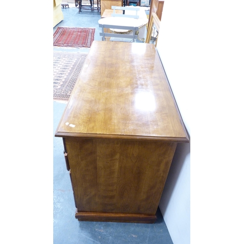 399 - Victorian-style walnut kneehole desk and a similar swivel ladder-back desk chair.  (2)