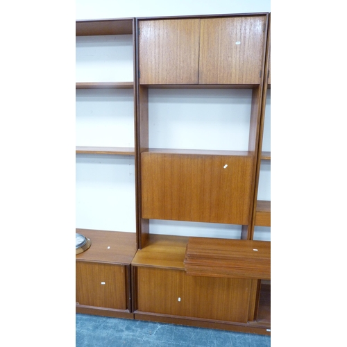 404 - G Plan retro teak modular wall unit with shelves and cupboards in sections and a wall clock.