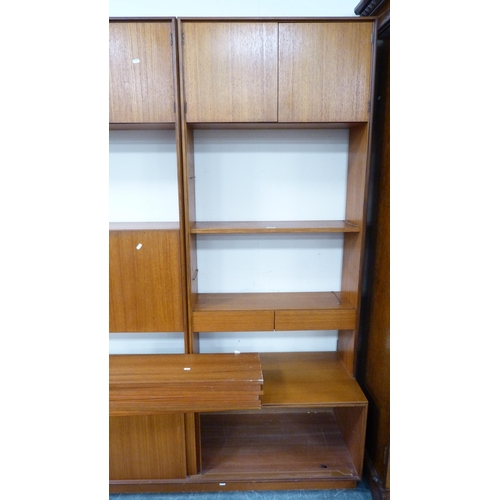 404 - G Plan retro teak modular wall unit with shelves and cupboards in sections and a wall clock.