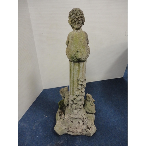 433 - Stone garden figure in the form of a mythical child seated on a fluted stand with applied rabbits an... 