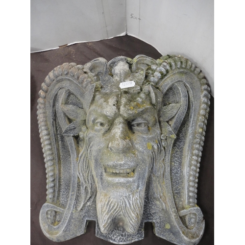 452 - Near pair of stone garden wall masks in the form of gargoyles.  (2)