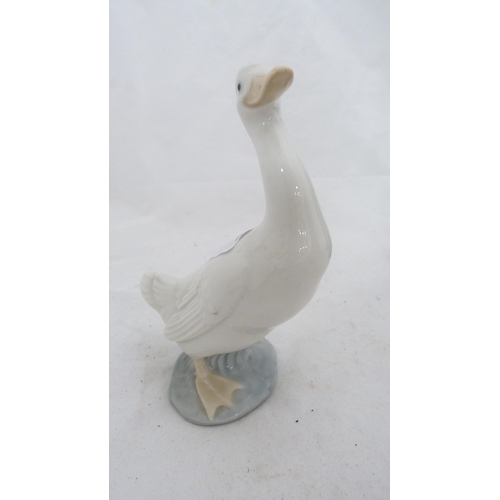 80 - Porcelain tea cosy finial figure, Nao figure of a goose, pair of Art Deco-style figurines and a shoe... 