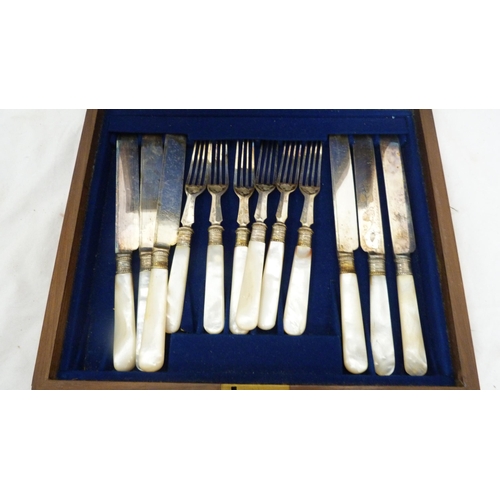 97 - Boxed set of twelve EP fruit knives and forks with mother of pearl handles.