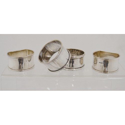 62 - Silver butter shell, a silver toast rack, various silver and an EP napkin ring, 390g gross.