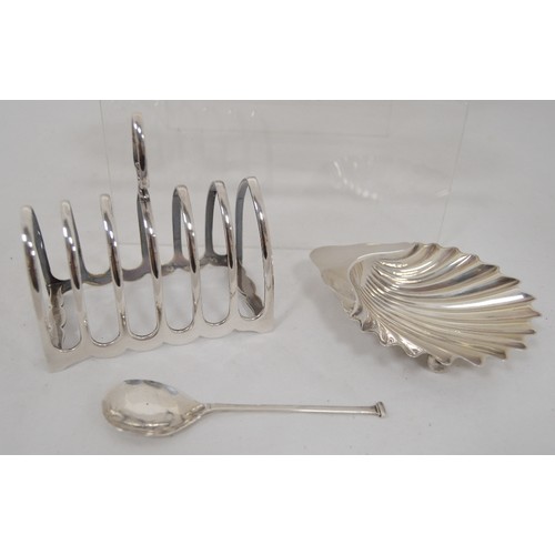 62 - Silver butter shell, a silver toast rack, various silver and an EP napkin ring, 390g gross.