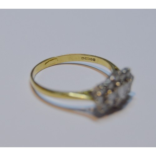 154 - Diamond oval cluster ring set with baguettes and brilliants, 18ct gold, size R, 3.4g gross.