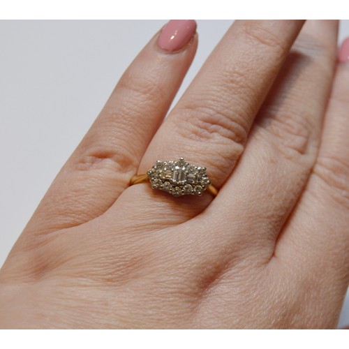 154 - Diamond oval cluster ring set with baguettes and brilliants, 18ct gold, size R, 3.4g gross.