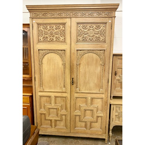 670 - Ornate carved bedroom suite comprising side table with fitted drawers, side unit and large wardrobe ... 