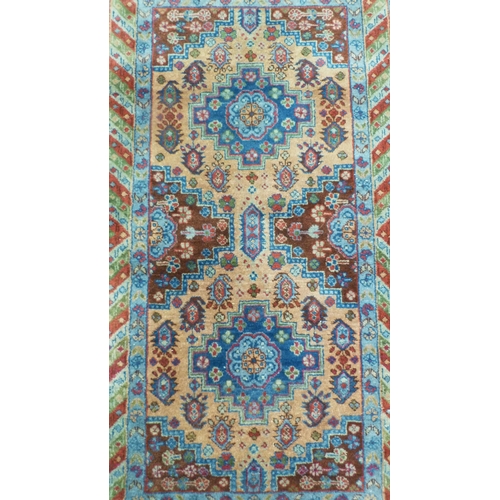 394 - Afghan Kaynak hand-knotted rug with two geometric medallions to the centre, on a blue field, within ... 