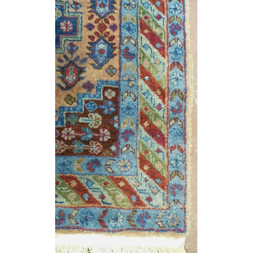 394 - Afghan Kaynak hand-knotted rug with two geometric medallions to the centre, on a blue field, within ... 