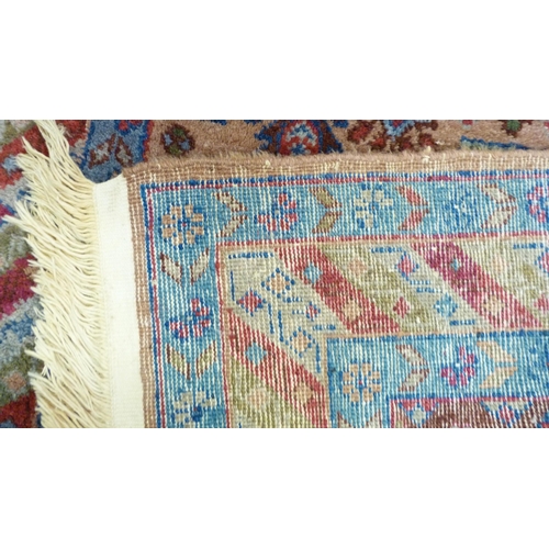 394 - Afghan Kaynak hand-knotted rug with two geometric medallions to the centre, on a blue field, within ... 