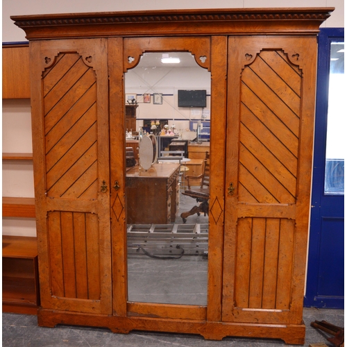 435 - Late Victorian Pugin-style pitch pine wardrobe, the central mirrored pivot door flanked by panelled ... 