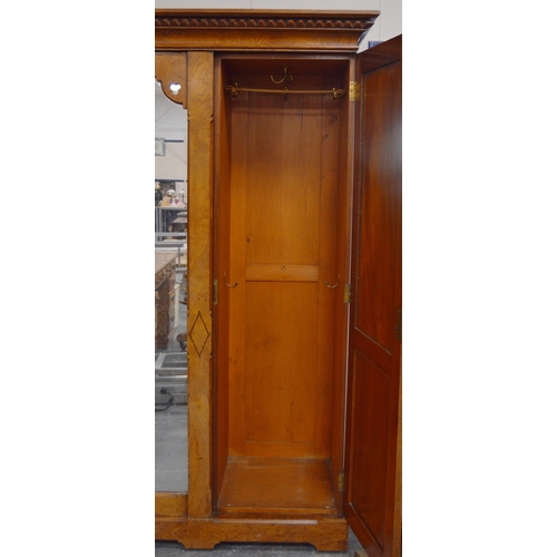 435 - Late Victorian Pugin-style pitch pine wardrobe, the central mirrored pivot door flanked by panelled ... 