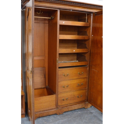 435 - Late Victorian Pugin-style pitch pine wardrobe, the central mirrored pivot door flanked by panelled ... 