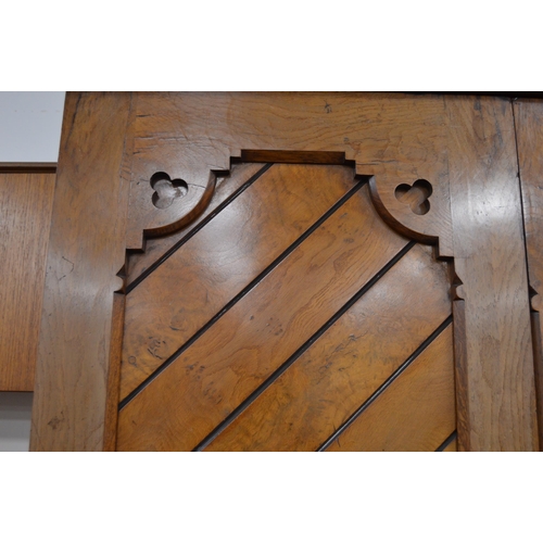 435 - Late Victorian Pugin-style pitch pine wardrobe, the central mirrored pivot door flanked by panelled ... 