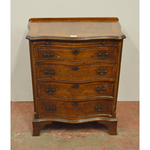 449 - Walnut serpentine chest of small proportions, with a brushing slide above four graduated drawers, on... 