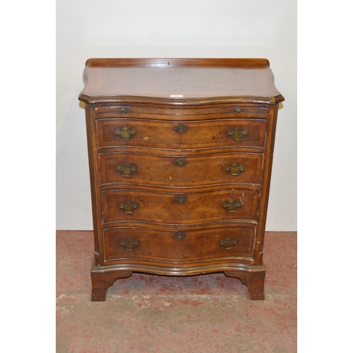 449 - Walnut serpentine chest of small proportions, with a brushing slide above four graduated drawers, on... 