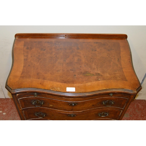 449 - Walnut serpentine chest of small proportions, with a brushing slide above four graduated drawers, on... 