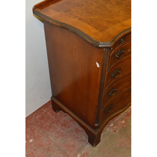 449 - Walnut serpentine chest of small proportions, with a brushing slide above four graduated drawers, on... 