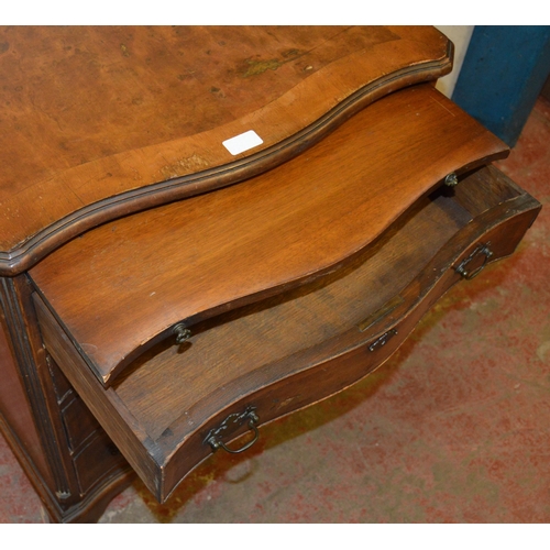 449 - Walnut serpentine chest of small proportions, with a brushing slide above four graduated drawers, on... 