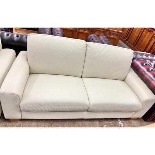 633 - Pair matching two-piece cream leather settees