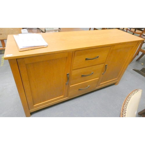 485 - Modern light oak sideboard with three drawers flanked by two doors.L.153cm x D.45cm x H.85cm