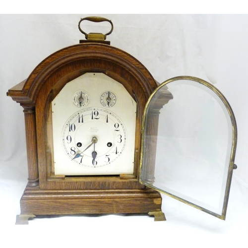 195 - Continental oak-cased bracket clock, c. early 20th century, the arched shaped clock with twin reeded... 